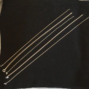 Five Silver chain necklaces.
